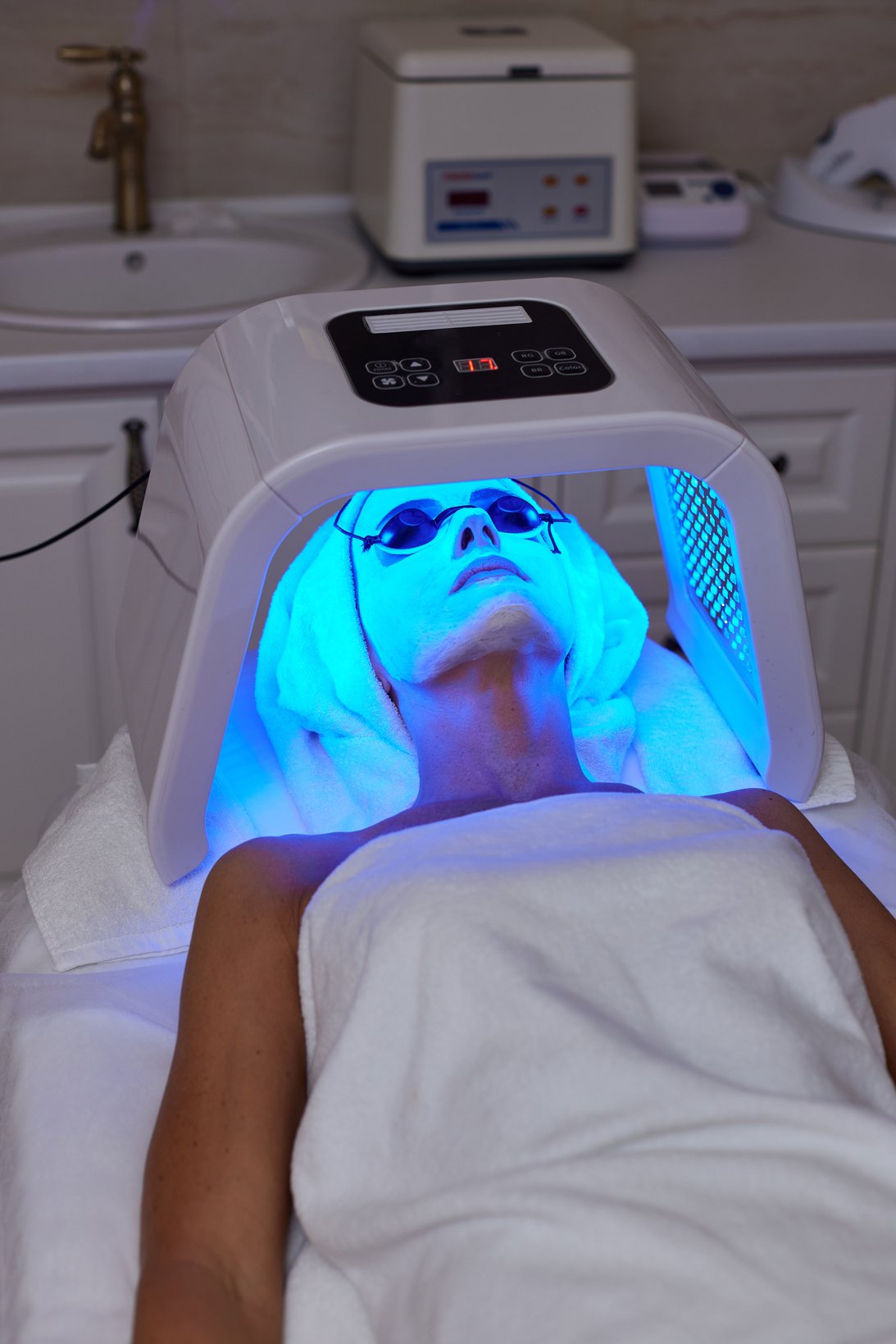 Woman Getting Facial Treatment with Led .